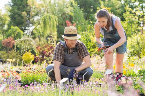 Team of gardeners preparing tools at a garden job site